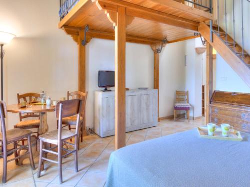 a room with a table and chairs and a television at Farmhouse in Marsciano with vineyards olive groves in Marsciano