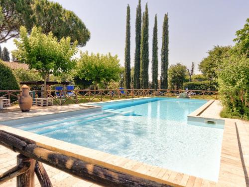 a swimming pool in a yard with trees at Farmhouse in Marsciano with vineyards olive groves in Marsciano