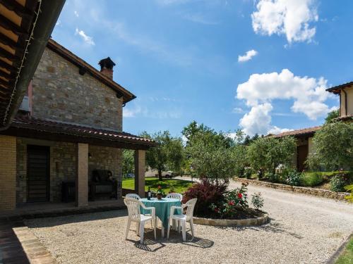 a patio with a table and chairs in front of a building at Farmhouse in Perugia with Swimming Pool in Perugia
