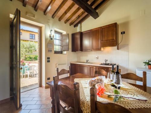 a kitchen and dining room with a table and a dining room at Farmhouse in Perugia with Swimming Pool in Perugia