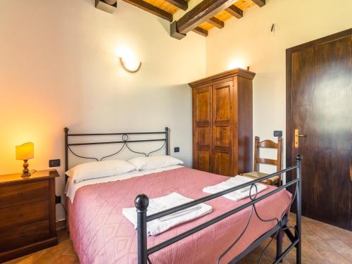 a bedroom with a bed with a pink bedspread at Farmhouse in Perugia with Swimming Pool in Perugia