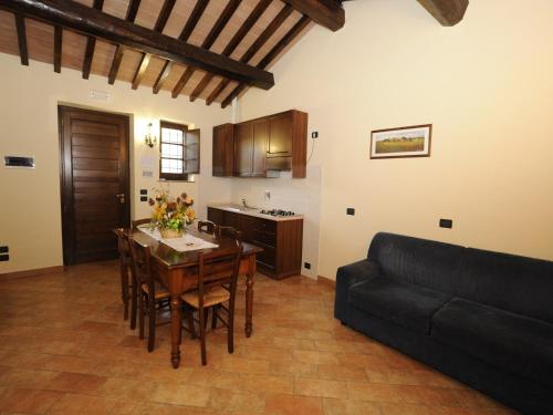 a kitchen and dining room with a table and a couch at Farmhouse in Perugia with Swimming Pool in Perugia