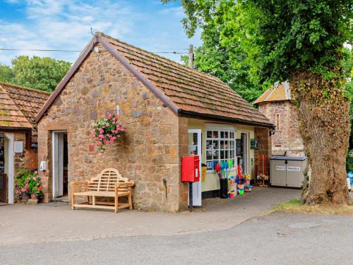 a small brick building with a bench in front of it at 3 Bed in West Quantoxhead 96235 in West Quantoxhead