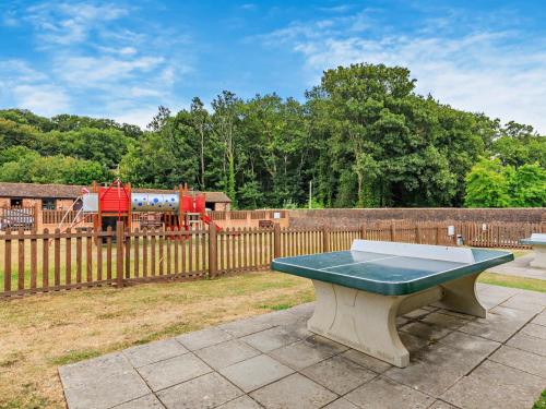 a ping pong table in a yard with a playground at 3 Bed in West Quantoxhead 96235 in West Quantoxhead