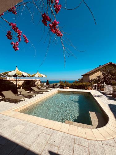 a swimming pool with chairs and a view of the ocean at Villa Casa Nova - with Heated Pool in Balchik