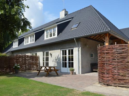 a house with a picnic table in front of it at Pleasant Holiday Home near the centre of Haaren in Haaren