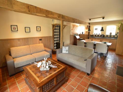 a living room with a couch and a table at Pleasant Holiday Home near the centre of Haaren in Haaren