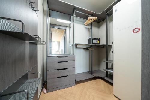a room with a walk in closet with a drawer at Brown Suites Busan Station in Busan