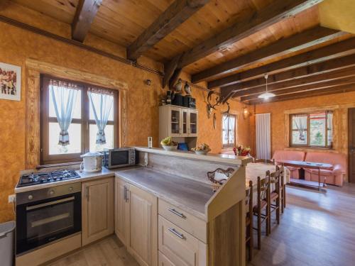 a kitchen with a stove and a counter top at Tranquil Holiday Home in Kvarner near Kupa River in Brod Moravice