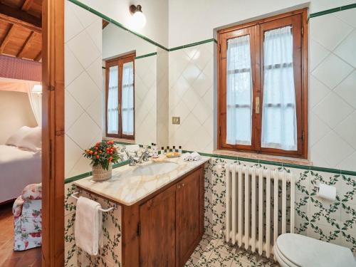 a bathroom with a sink and a toilet and a window at Unique country house in an old hamlet in Monte Castelli