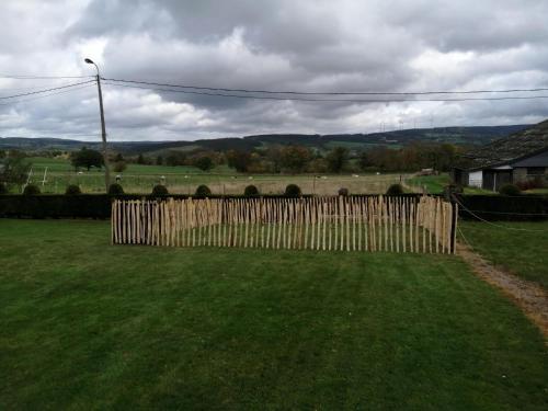 a wooden fence in a yard with a field at Test Property Sophisticated Holiday Home in Lierneux near forest in Lierneux