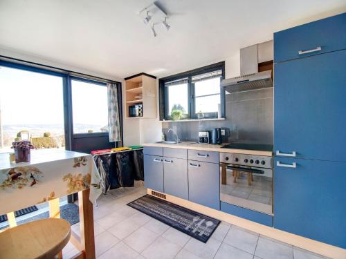 a kitchen with blue cabinets and a blue stove at Test Property Sophisticated Holiday Home in Lierneux near forest in Lierneux