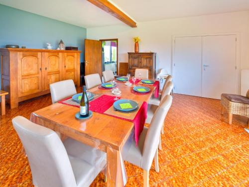 a dining room with a wooden table and white chairs at Test Property Sophisticated Holiday Home in Lierneux near forest in Lierneux