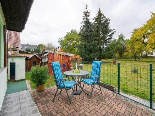 a patio with a table and chairs and a playground at Peaceful Apartment in Lichtenhain with Private Terrace in Lichtenhain