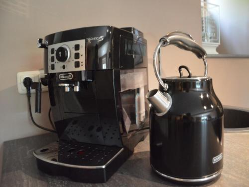 a coffee maker and a tea kettle on a counter at Stunning Holiday Home near Forest in Slenaken in Slenaken