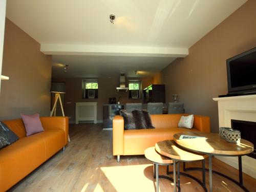 a living room with a couch and a table at Stunning Holiday Home near Forest in Slenaken in Slenaken