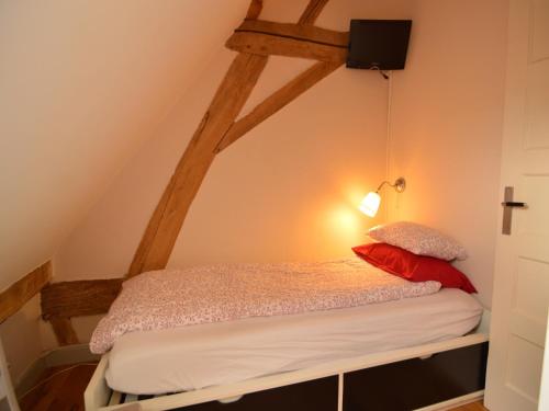 a bedroom with a bed with a light on the wall at Stunning Holiday Home near Forest in Slenaken in Slenaken