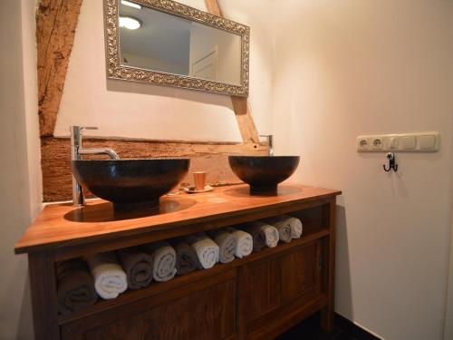 a bathroom with two sinks and a mirror at Stunning Holiday Home near Forest in Slenaken in Slenaken