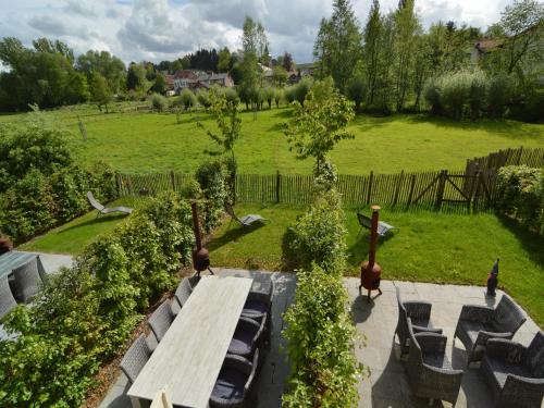 a garden with a wooden bench in a field at Stunning Holiday Home near Forest in Slenaken in Slenaken