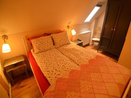 a bedroom with a large bed with a red comforter at Stunning Holiday Home near Forest in Slenaken in Slenaken