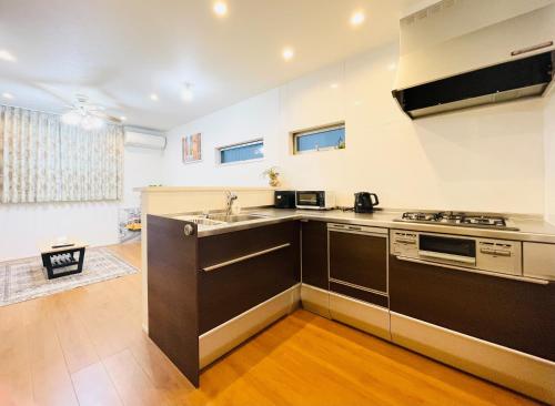 a kitchen with a sink and a stove at Alo BnB 5 - Near NIPPORI, SENDAGI, YANAKA GINZA, UENO - Self check-in in Tokyo