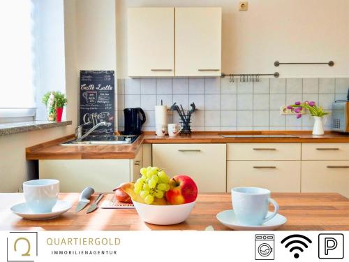 a kitchen with a bowl of fruit on a table at Monteurwohnung mit Stil in Schwarzheide