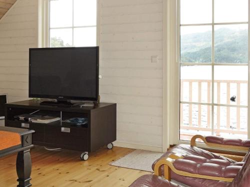 a living room with a flat screen tv on a table at 11 person holiday home in hebnes in Hebnes