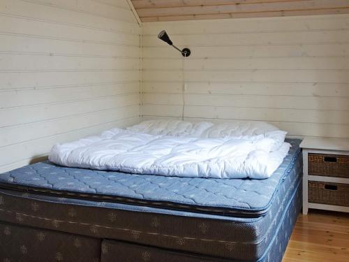 a bed in the corner of a room at 11 person holiday home in hebnes in Hebnes