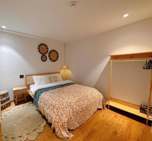 a bedroom with a bed and a clock on the wall at COCO HOUSE Bùi Thị Xuân, Đà Lạt in Da Lat