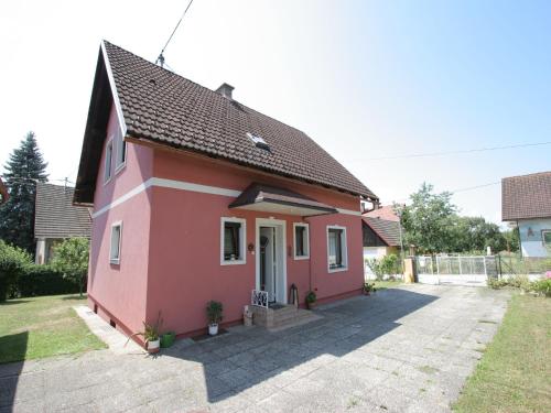 a small pink house in a yard at Modern apartment with garden near the Petzen ski area in Eberndorf Carinthia in Eberndorf