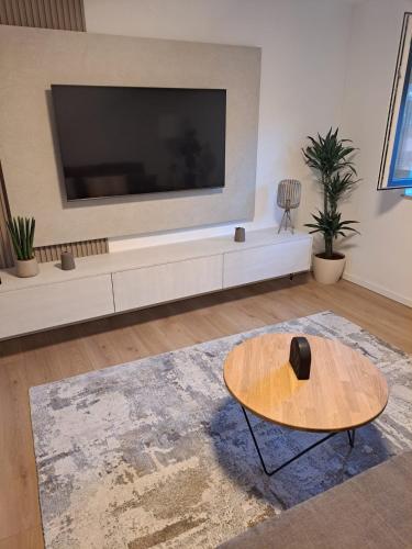 a living room with a large tv and a coffee table at Apartments Oriens 7 in Zagreb