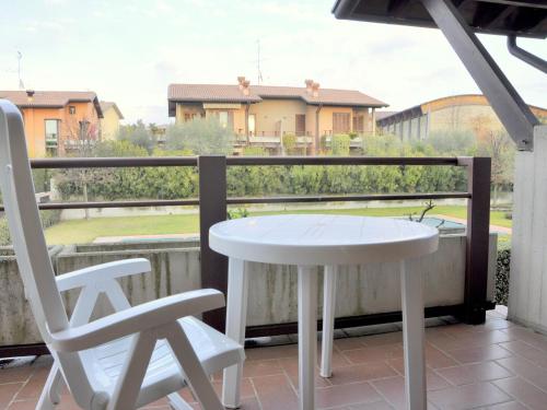 a white table and two chairs on a balcony at Charming Holiday home in Lazise with Swimming Pool in Lazise