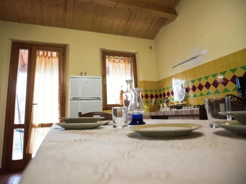a kitchen with a table with plates on it at Holiday Home in Paciano with Swimming Pool,Terrace,Billiards in Paciano