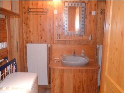 a bathroom with a sink and a mirror at Chalet in Harreberg with Garden Views in Harreberg