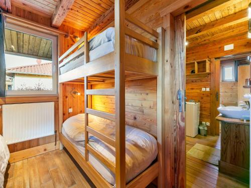 a bedroom with bunk beds in a wooden cabin at Chalet in Harreberg with Garden Views in Harreberg