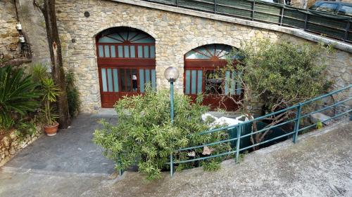 a building with a fence and plants in front of it at U Ciousu by Ligurian Life APPARTAMENTI IN AGRITURISMO in Vallebona