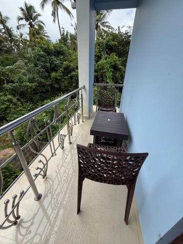 a table and chairs sitting on a balcony at Serene Palolem guest house in Palolem