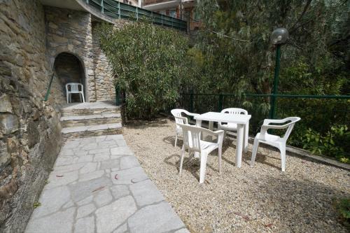 a white table and chairs sitting next to a building at U Ciousu by Ligurian Life APPARTAMENTI IN AGRITURISMO in Vallebona