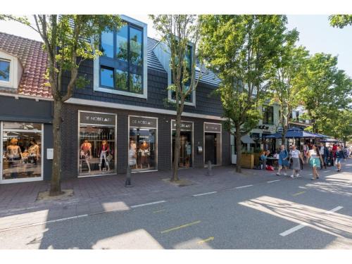 a group of people walking in front of a store at Appealing apartment in Domburg near the beach in Domburg