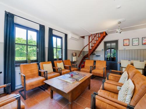 a living room filled with furniture and a table at Atmospheric country house in Asten on a golf course in Asten