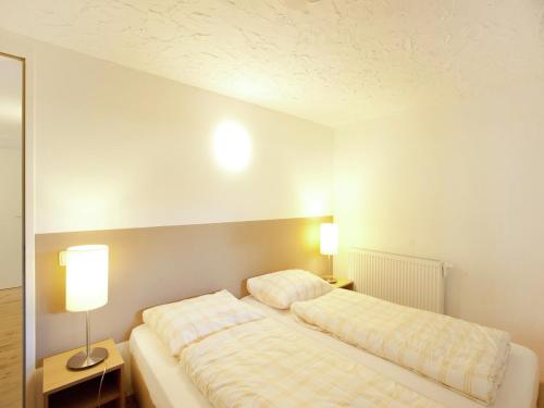 a bedroom with two beds and two lamps at Chalet in the Wilder Kaiser ski area in Tyrol in Wörgl