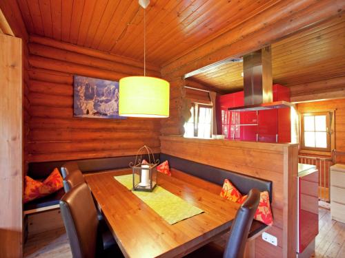 a dining room with a wooden table and chairs at Chalet in the Wilder Kaiser ski area in Tyrol in Wörgl