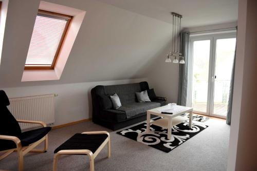a living room with a couch and a table at Annabell in Kühlungsborn