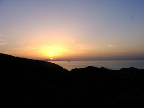 a sunset over the ocean with the sun in the sky at Holiday Home with Garden in Kritinia in Kritinía
