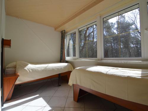 a bedroom with two beds and a window at Villa in Lunteren with Heated Pool in Lunteren