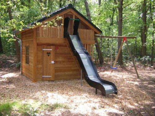 a play house with a slide in front of it at Villa in Lunteren with Heated Pool in Lunteren