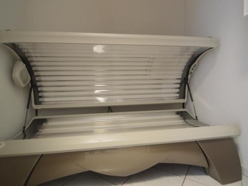 a white shelf in a room with a window at Villa in Lunteren with Heated Pool in Lunteren