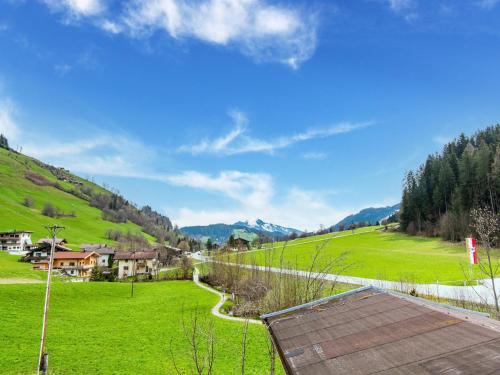 a view of a green field with houses on a hill at Pretty Apartment in Oberau with Infrared Sauna in Oberau