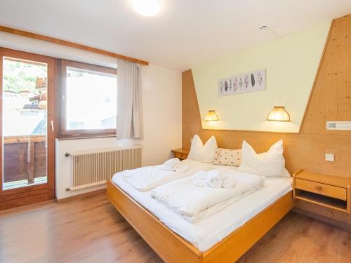 a bedroom with a large bed with white sheets at Pretty Apartment in Oberau with Infrared Sauna in Oberau