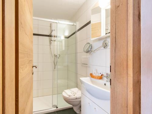 a bathroom with a shower and a toilet and a sink at Pretty Apartment in Oberau with Infrared Sauna in Oberau